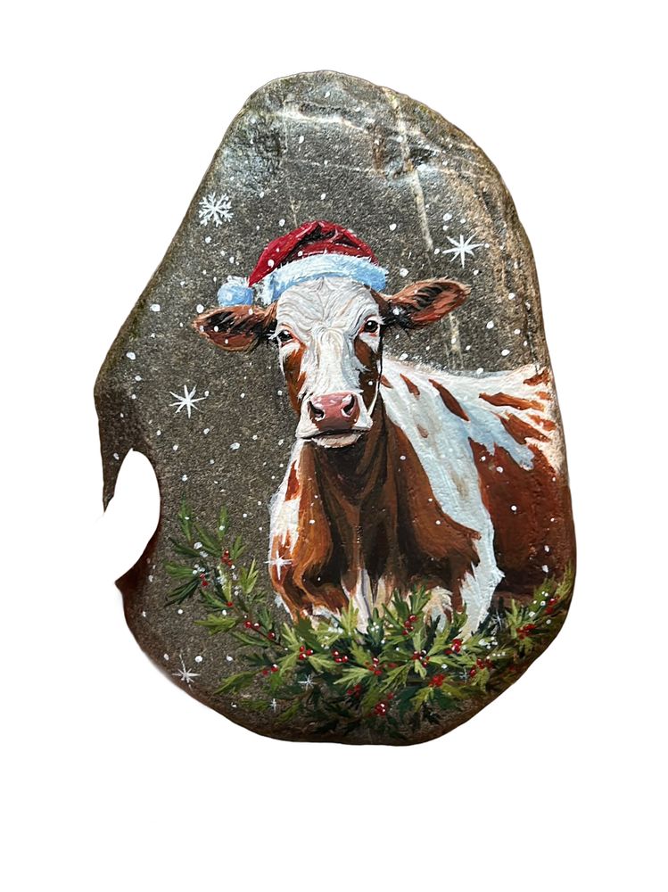 Cow with Santa hat painted on a stone